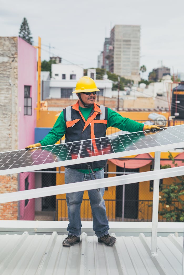 A solar technician adjusts photovoltaic panels on a colorful urban rooftop.